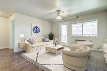 a living room with white furniture and a ceiling fan at Madison Park, Bozeman, 59718